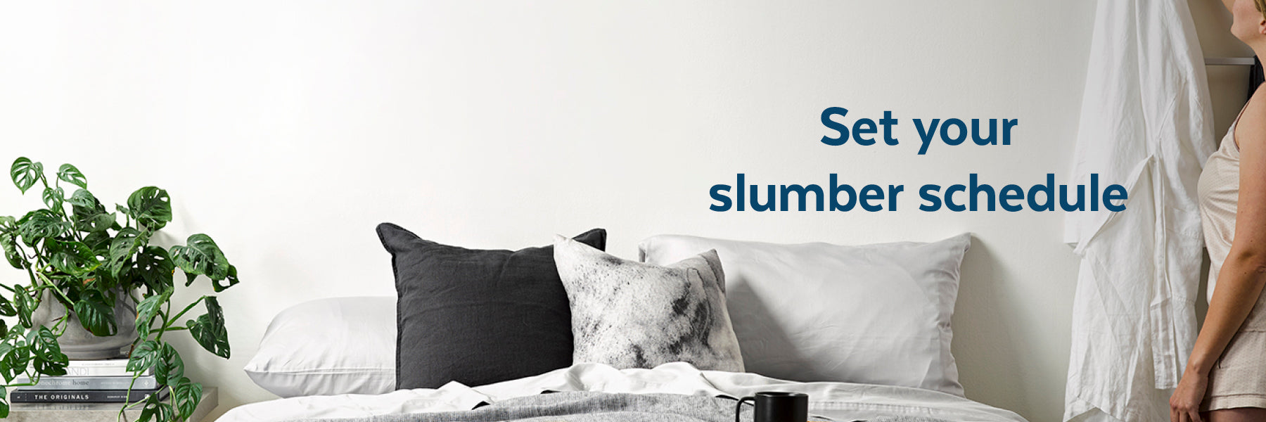 Girl hanging up robe before bed with text 'Set your slumber schedule'